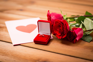 Image showing close up of diamond ring, roses and greeting card