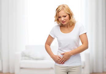 Image showing unhappy woman suffering from stomach ache