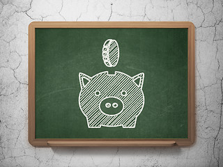 Image showing Money concept: Money Box With Coin on chalkboard background