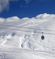 Image showing Gondola lift and ski slope at sun day