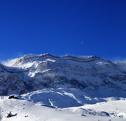 Image showing Snowy rocks at sun windy day