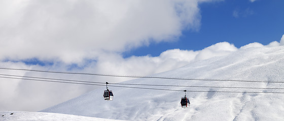 Image showing Panoramic view on gondola lifts and off-piste slope at sun day