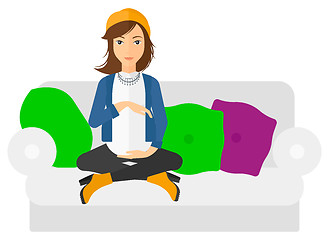 Image showing Pregnant woman sitting on sofa.