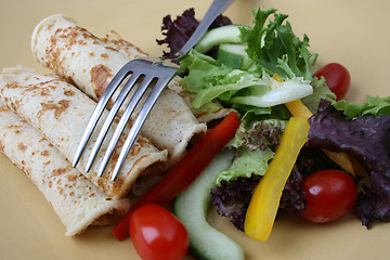 Image showing Salad and pancakes with fork