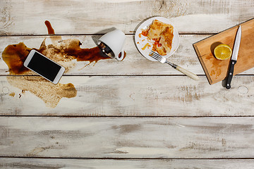 Image showing Cup of coffee spilled on wooden table