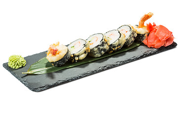 Image showing set of sushi on black slate substrate, isolated white background