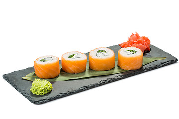 Image showing set of sushi on black slate substrate, isolated white background