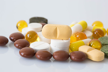 Image showing Pile of various colorful pills isolated on white