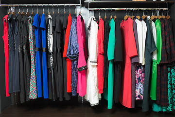 Image showing women\'s dresses on hangers in a retail shop