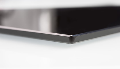 Image showing black sheet glass on a white. closeup