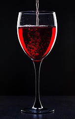 Image showing Red wine pouring