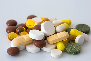 Image showing Pile of various colorful pills isolated on white