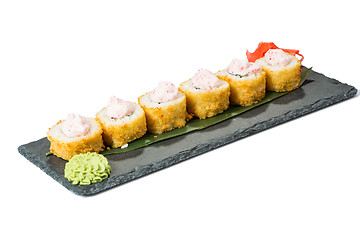 Image showing set of sushi on black slate substrate, isolated white background