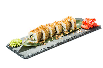 Image showing set of sushi on black slate substrate, isolated white background