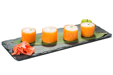 Image showing set of sushi on black slate substrate, isolated white background