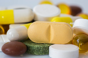 Image showing Pile of various colorful pills isolated on white