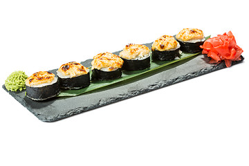 Image showing set of sushi on black slate substrate, isolated white background