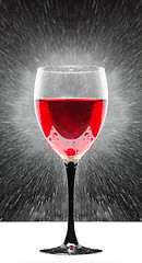 Image showing glass with red wine. splashing water