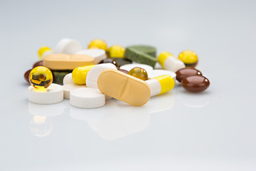 Image showing Pile of various colorful pills isolated on white