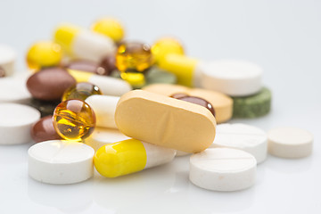 Image showing Pile of various colorful pills isolated on white