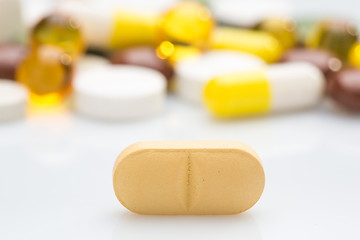 Image showing Pile of various colorful pills isolated on white