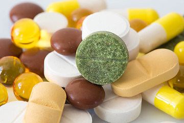 Image showing Pile of various colorful pills isolated on white