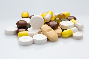 Image showing Pile of various colorful pills isolated on white