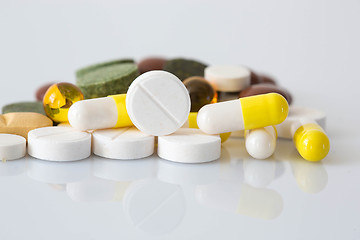 Image showing Pile of various colorful pills isolated on white