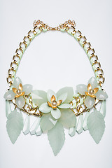 Image showing plastic necklace. beige flower