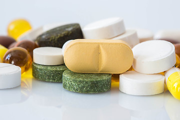 Image showing Pile of various colorful pills isolated on white