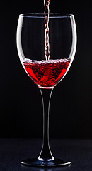 Image showing Red wine pouring