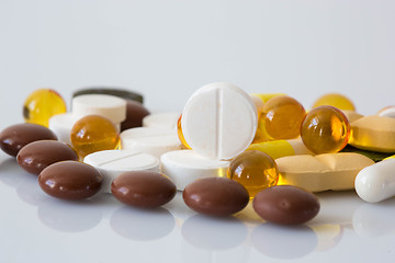 Image showing Pile of various colorful pills isolated on white