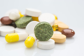 Image showing Pile of various colorful pills isolated on white