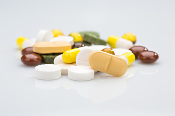 Image showing Pile of various colorful pills isolated on white