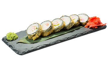 Image showing set of sushi on black slate substrate, isolated white background