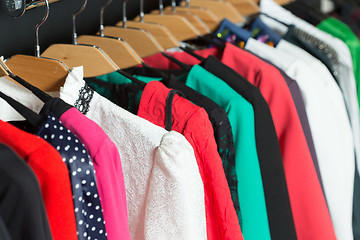 Image showing women\'s dresses on hangers in a retail shop