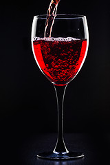 Image showing Red wine pouring