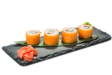 Image showing set of sushi on black slate substrate, isolated white background