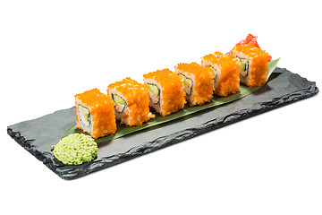 Image showing set of sushi on black slate substrate, isolated white background