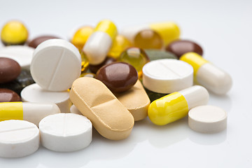 Image showing Pile of various colorful pills isolated on white