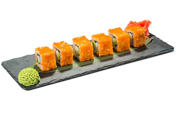 Image showing set of sushi on black slate substrate, isolated white background