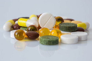 Image showing Pile of various colorful pills isolated on white