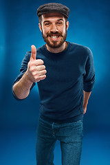Image showing The young man showing  the ok thumbs up hand sign