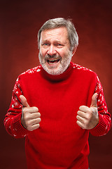 Image showing Elderly man showing ok sigh on a red background