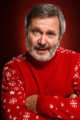 Image showing Elderly  smiling man on a red background