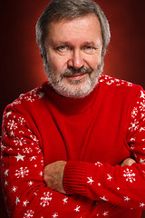 Image showing Elderly  smiling man on a red background