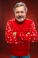 Image showing Elderly  smiling man on a red background