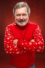 Image showing Elderly  smiling man on a red background