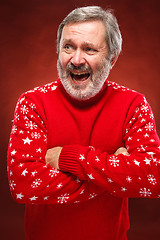 Image showing Elderly  smiling man on a red background