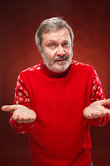 Image showing Elderly  smiling man on a red background